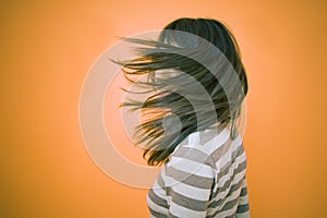 Teen Obscured By Blowing Hair photo