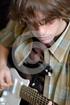 Teen playing guitar