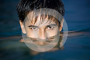 Teen in pool, having plunged on eyes into water