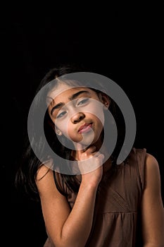 Teen posing over black backdrop