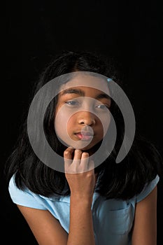 Teen posing over black backdrop