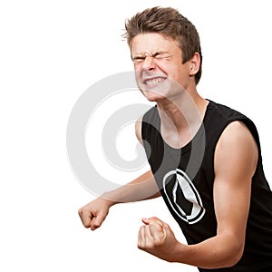 Teen pulling a fist with eyes closed.