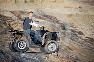 Teen on quad ATV in the hills