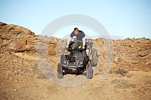 Teen on quad - four wheeler in hills