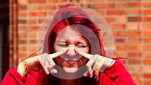 A Teen Redhead Making Funny Faces