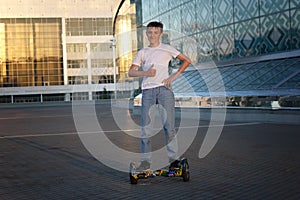 Teen rides on an electric scooter, with a smile and positive emotions