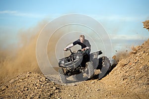 Teen riding quad ATV in hills