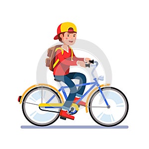 Teen school boy cycling on bicycle with backpack