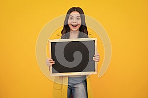 Teen schoolgirl hold blackboard. Child advertising. Back to school. Happy teenager, positive and smiling emotions of