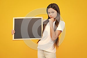 Teen schoolgirl hold blackboard. Child advertising. Back to school. Thinking face, thoughtful emotions of teenager girl.