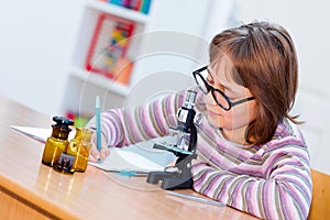 Teen science girl with microscope