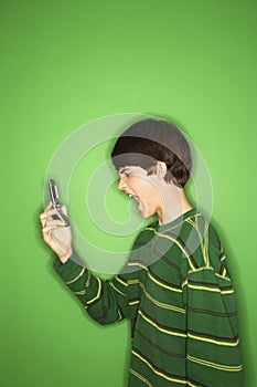 Teen screaming at cellphone.