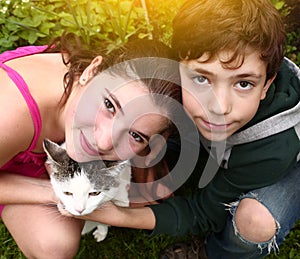Teen siblings boy and girl with cat
