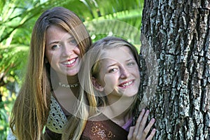 Teen Sisters By Tree