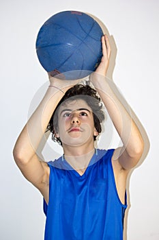 Teen sportsman holding basketball