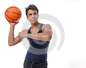 Teen sportsman with sportswear playing basketball. White background.