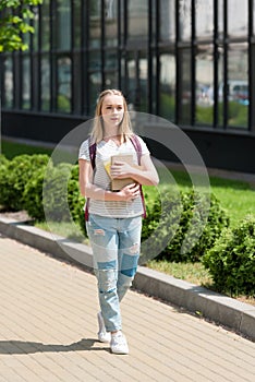 teen student girl with books walking