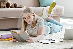 teen student girl reading book while lying