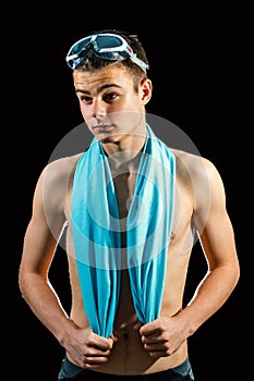 Teen swimmer against black background.