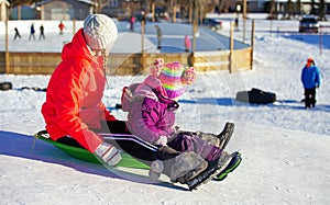 Teen and toddler sledding
