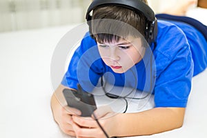 Teen using cell phone with headphones