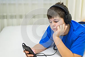 Teen using cell phone with headphones