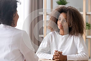 Teen visiting clinic listening medical worker sitting at doctors office