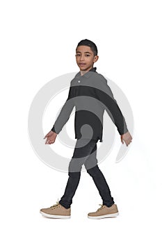 Teen walking and looking at camera on white