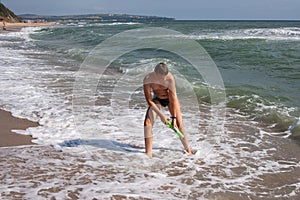 Teen with a water gun at sea