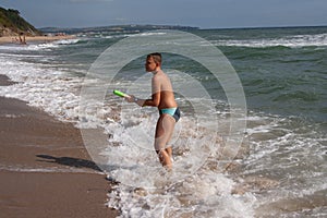 Teen with a water gun at sea