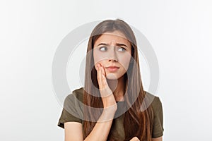 Teen woman pressing her bruised cheek with a painful expression as if she is having a terrible tooth ache