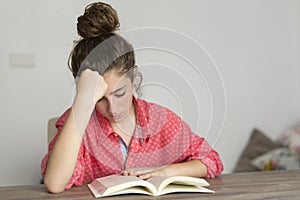 Teen woman reading a book. photo