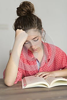 Teen woman reading a book. photo