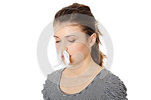 Teen woman with tissue in her nose