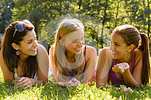 Teen women talking and relaxing in park