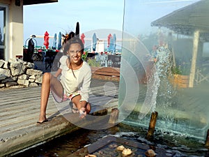 Teen 11 years with a fountain in a spa