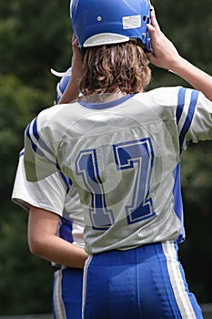 Teen Youth Football Player Putting on Helmut