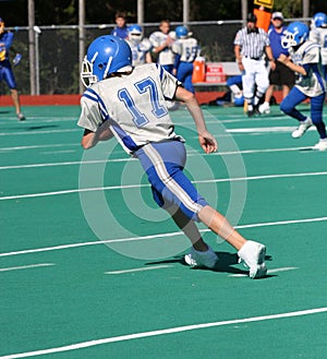 Teen Youth Football Player Running with the Ball