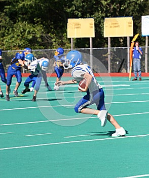 Teen Youth Football Player Running with the Ball