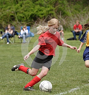 Teen Youth Soccer Player Kicking Ball