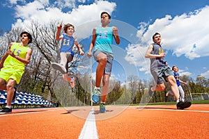 Teenage athletes having fun on the racetrack