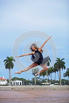 Teenage Ballet Dancer Leaping Over Sidewalk 