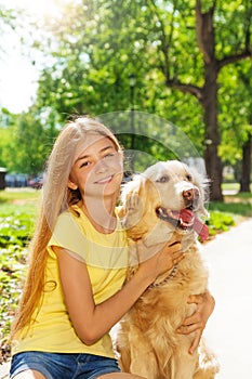 Teenage blonde girl with retriever dog otside