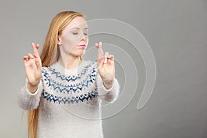 Teenage blonde woman making promise gesture