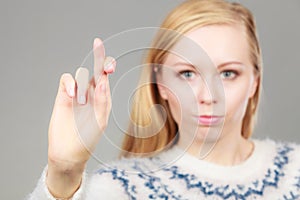 Teenage blonde woman making promise gesture