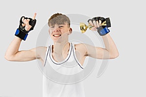 Teenage boxer boy with a trophy