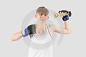 Teenage boxer boy with a trophy