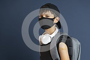 Teenage boy with adhesive bandage plaster on his arm after vaccination. Vaccine and health care for childen and