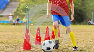 A teenage boy attending soccer training on the school field. Youth on physical education class