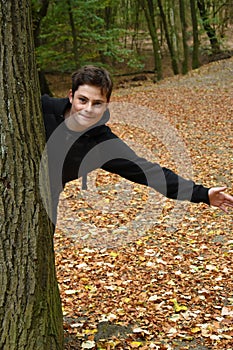 Teenage boy in autumn forest